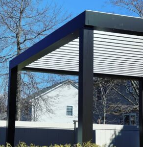 Contemporary aluminum pergola featuring an adjustable louvered roof system installed in a Virginia backyard.