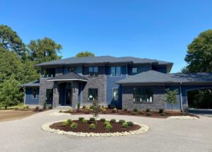 landscaped home with round driveway and center landscaping