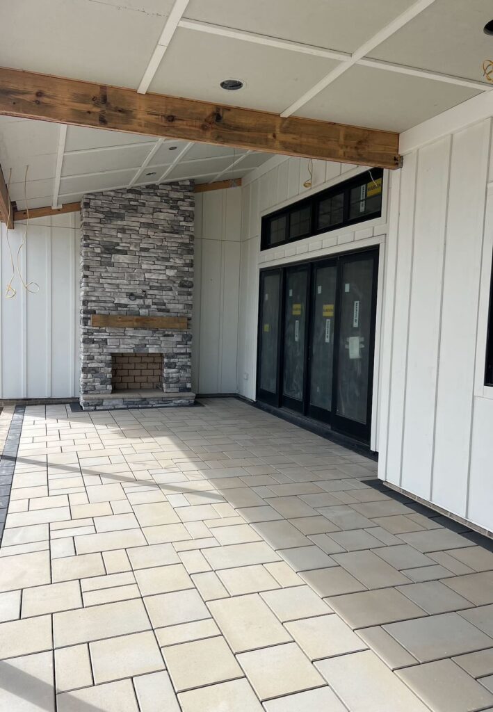 Paver patio with modern outdoor seating area next to Virginia home