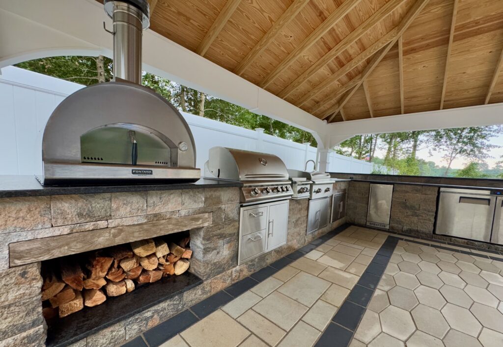 Covered outdoor pavilion with linear gas fireplace and seating